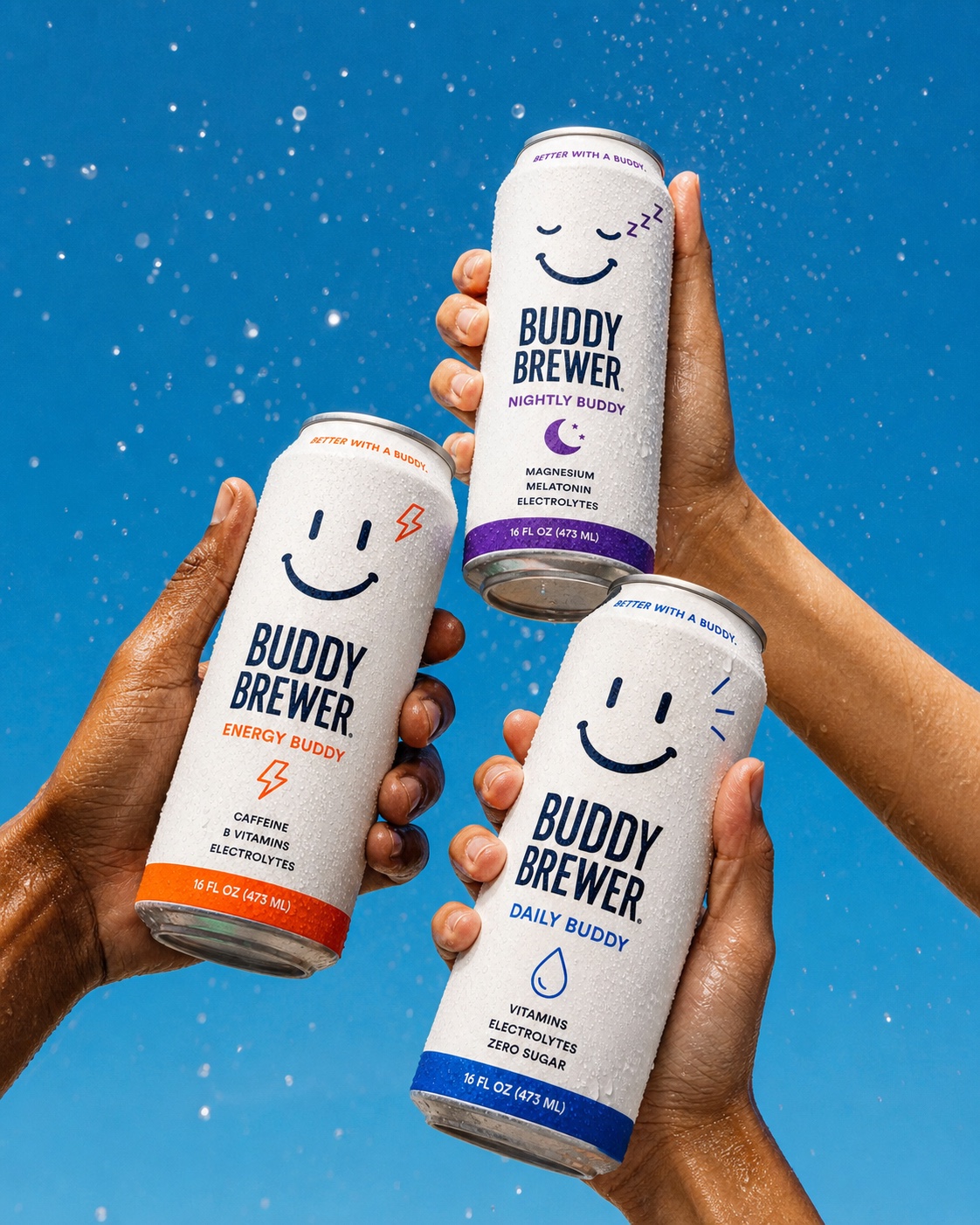 Three hands raise Energy, Daily, and Nightly Buddy cans together beneath sparkling water droplets.