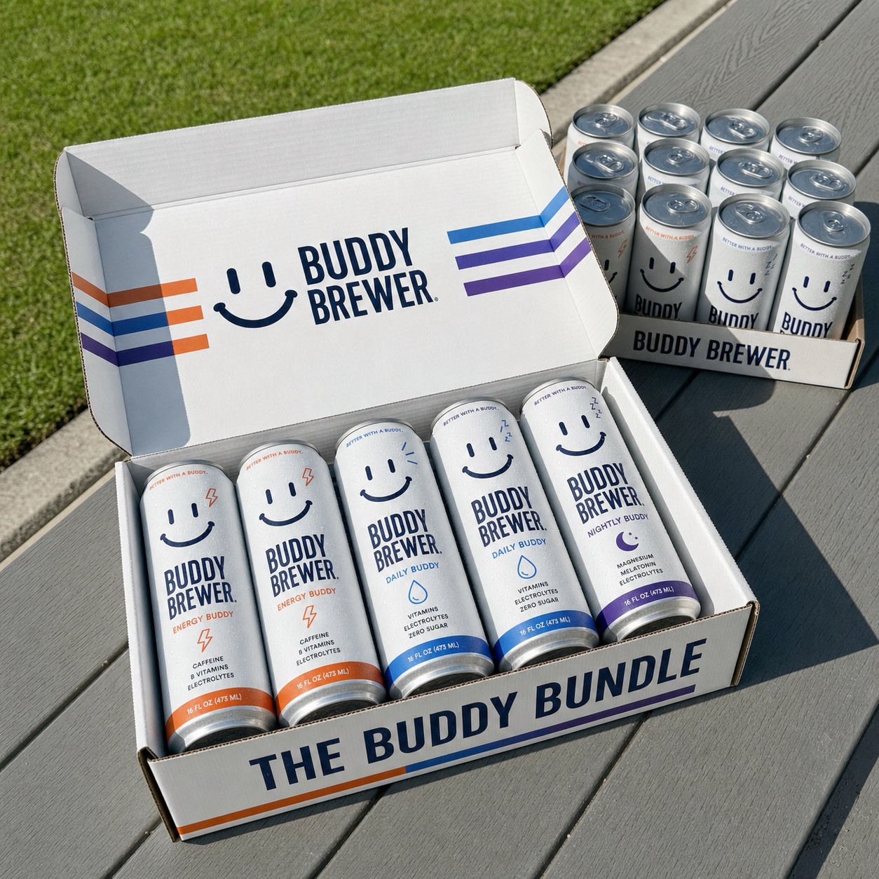 An open Buddy Bundle case of Energy, Daily, and Nightly Buddy cans on a sunny patio table